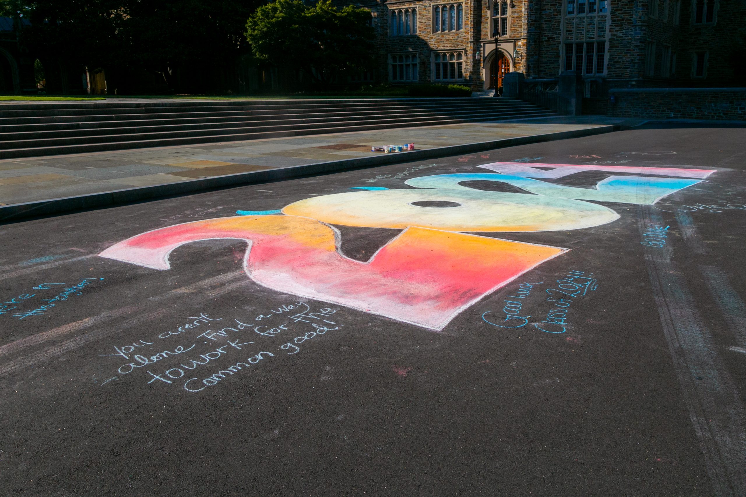 The photo shows the hand-written messages around the chalk mural.