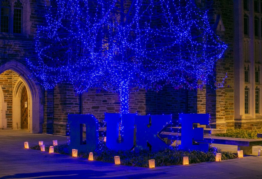 The University Communications team wrapped cardboard letters in blue string lights and placed them at the bottom of a decorated tree for a holiday video.