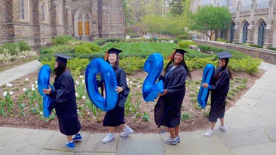 Duke graduates spin around holding balloons spelling out their class year, 2021.